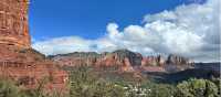 Dramatic clouds drift across Sedona’s sculpted red-rock skyline