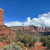 Dramatic clouds drift across Sedona’s sculpted red-rock skyline