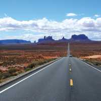 A long open road through Monument Valley | Jake Hutchins