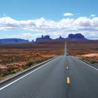 A long open road through Monument Valley | Jake Hutchins