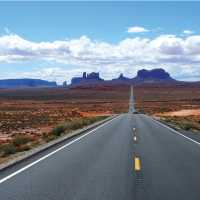 A long open road through Monument Valley | Jake Hutchins