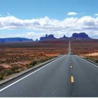 A long open road through Monument Valley | Jake Hutchins